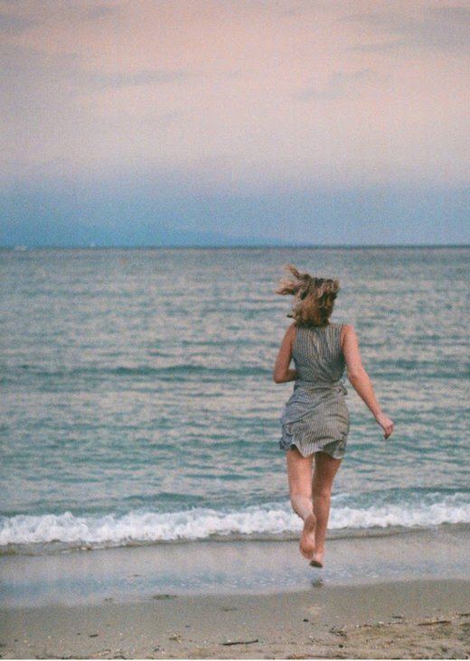 A person running toward the sea